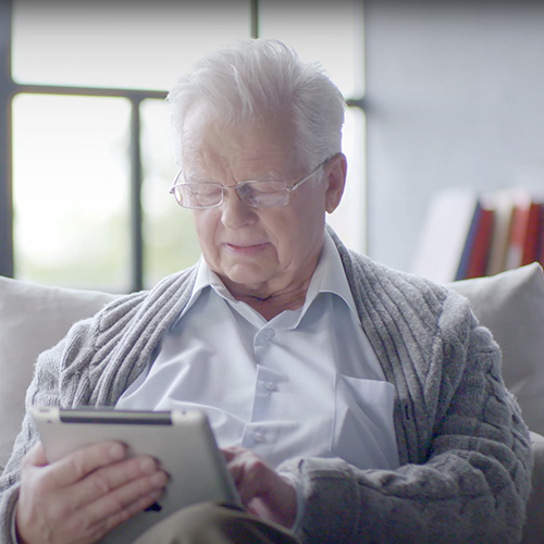 Grandpa looking at electronic tablet